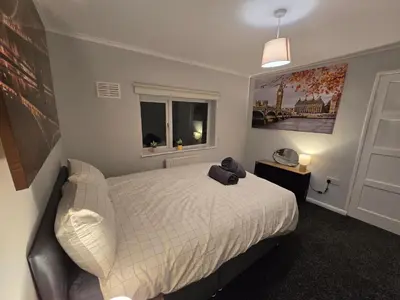 a bedroom with a white bed and a window at Shrewsbury Creations in Shrewsbury