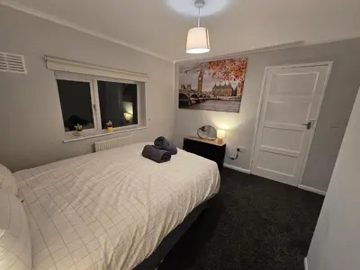 a bedroom with a white bed and a window at Shrewsbury Creations in Shrewsbury