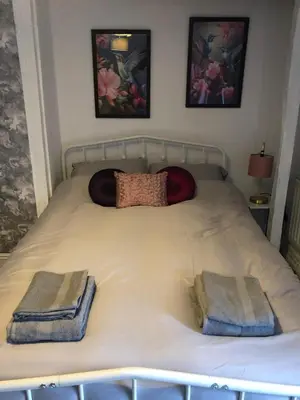 a bed with two towels on top of it at The Eagles Inn in Rhayader