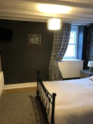 a bedroom with a bed and a window at The Eagles Inn in Rhayader