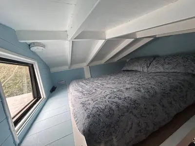a bedroom with a bed and a window in it at Bon yr Llew, Coity Bach in Brecon