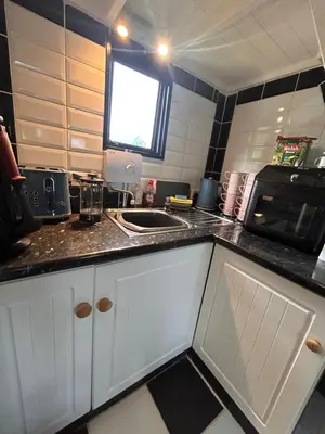 a kitchen with a sink and a microwave at Bon yr Llew, Coity Bach in Brecon