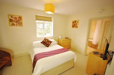 a bedroom with a bed and a television in it at The Castle Hotel in Talgarth