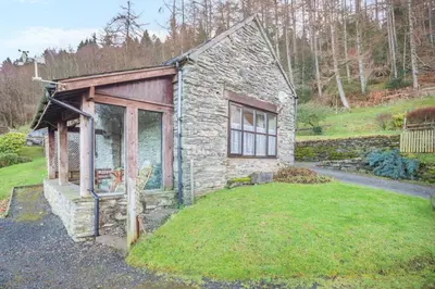 a small stone house with a grass yard at 1 Bed in Llandderfel oc-t30475 in Llandderfel