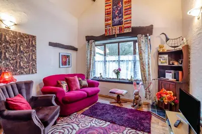 a living room with a red couch and a window at 1 Bed in Llandderfel oc-t30475 in Llandderfel