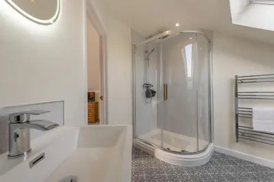 a white bathroom with a shower and a sink at 4 Bed in Aberarth oc-g30835 in Aberaeron