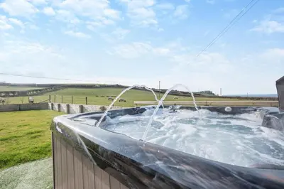 a hot tub with a water fountain in a field at 4 Bed in Aberarth oc-g30835 in Aberaeron