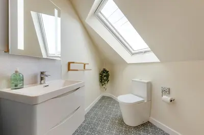 a bathroom with a sink and a toilet with skylights at 4 Bed in Aberarth oc-g30835 in Aberaeron