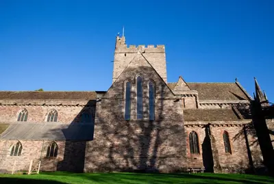 a large brick church with a tower on a green field at 4 Bed in Brecon oc-h30823 in Brecon