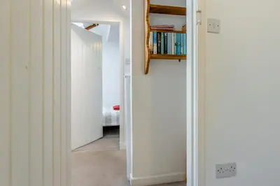 a hallway with white walls and a book shelf at 2 Bed in Llanuwchllyn oc-t30615 in Llanuwchllyn