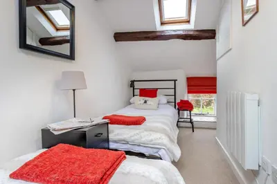 a bedroom with two beds with red pillows at 2 Bed in Llanuwchllyn oc-t30615 in Llanuwchllyn