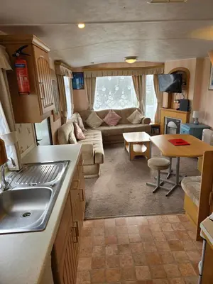 a kitchen and living room of an rv at Homely 2 Bedrommed Mobile Home E1 in Aberystwyth