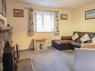 a living room with a couch and a table at Ysgubor Newydd Parc Isaf in Dyffryn