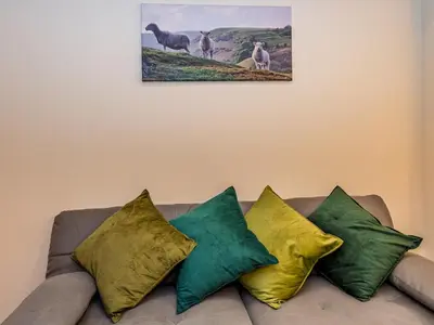 a bunch of pillows sitting on top of a couch at Spacious home sleeps 9 - walker cyclist retreat - Pass the Keys in Church Stretton