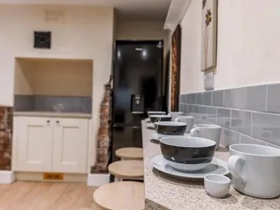 a kitchen with a counter with bowls and cups on it at Spacious home sleeps 9 - walker cyclist retreat - Pass the Keys in Church Stretton