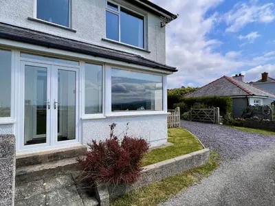 a house with large windows on the side of it at Glynmor in Harlech