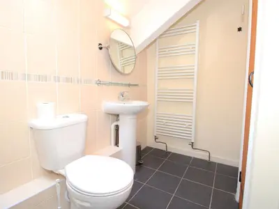a bathroom with a toilet and a sink at The Farmhouse in Llanbedr