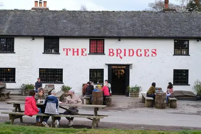 a group of people sitting outside of a building at The Bridges in Shrewsbury