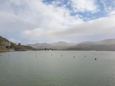 a large body of water with mountains in the background at Sandpiper Apartment in Barmouth