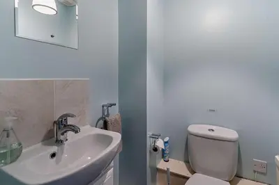 a bathroom with a white toilet and a sink at 3 Bed in Pentre Bach oc-t30863 in Pentre-bâch