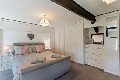 a bedroom with a large bed with white cabinets at 3 Bed in Pentre Bach oc-t30863 in Pentre-bâch