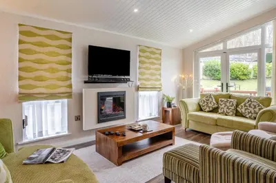 a living room with a couch and a tv at 2 Bed in Gilfachrheda oc-b30905 in Llanina