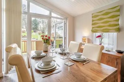 a dining room with a wooden table and chairs at 2 Bed in Gilfachrheda oc-b30905 in Llanina