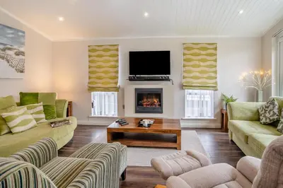a living room with two couches and a fireplace at 2 Bed in Gilfachrheda oc-b30905 in Llanina