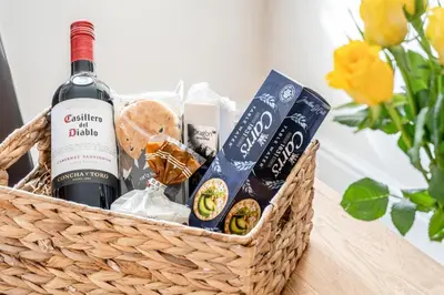 a basket of wine and snacks on a table at 2 Bed in Trecastle oc-c30837 in Trecastle