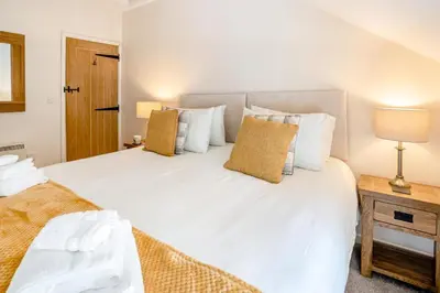 a bedroom with a large white bed with pillows at 2 Bed in Trecastle oc-c30837 in Trecastle