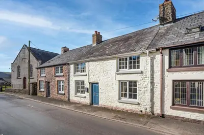 an old brick house with a blue door on a street at 2 Bed in Trecastle oc-c30837 in Trecastle