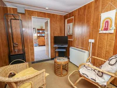 a room with wooden walls and a desk with a computer at Shed Your Blues in Hereford