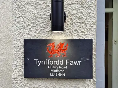a sign for ayrford farm on the side of a building at Tynffordd Fawr in Penrhyndeudreath