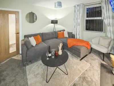 a living room with a couch and a table at Tynffordd Fawr in Penrhyndeudreath