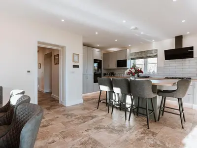 a kitchen and dining room with a table and chairs at Copper Beech Cottage in Welshpool
