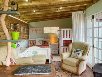 a childs bedroom with a bed and a chair at The Cabin In The Woods - Uk49023 in Pencarreg
