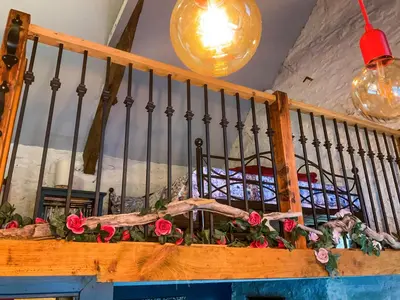 a balcony with flowers on a table in a room at Y Smithy - Uk49022 in Llanybydder