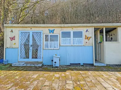 a small house with butterflies on the side of it at Rosie - Uk49025 in Pencarreg