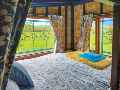 a bed in a room with a view of a window at Rosie - Uk49025 in Pencarreg