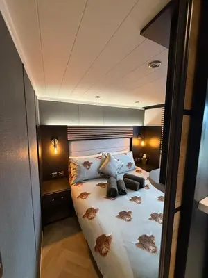 a bedroom with a large bed in a room at Lodges at Moody Meadows in Llanarth