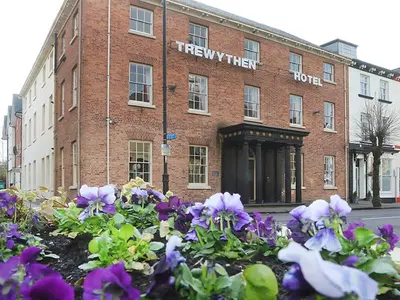 a hotel with purple flowers in front of a building at The Trewythen in Llanidloes