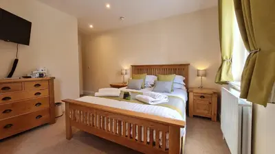 a bedroom with a bed with two towels on it at The Trewythen in Llanidloes