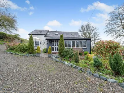 a house with a lot of plants in front of it at Rhydyfran Coach House in Cribyn