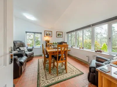 a living room with a table and chairs at Rhydyfran Coach House in Cribyn