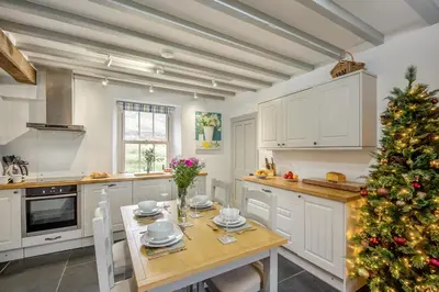 a christmas tree in a kitchen with a table at Beautiful Remote Cottage near Dolgellau in Penmaen Pool