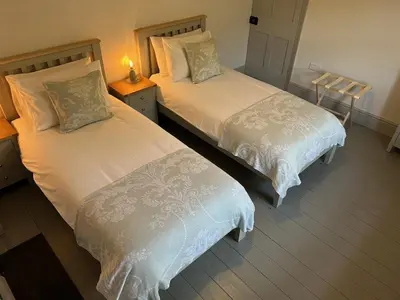 two beds sitting next to each other in a bedroom at Beautiful Remote Cottage near Dolgellau in Penmaen Pool