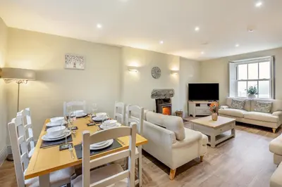 a dining room and living room with a table and chairs at Beautiful Remote Cottage near Dolgellau in Penmaen Pool