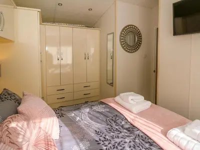 a bedroom with a bed with towels on it at 98 The Heron in New Quay