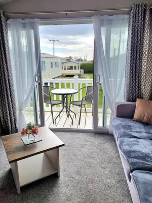 a living room with a couch and a table at Willerby Malton in Barmouth