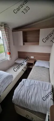 a room with two beds and a window at Caravan 133 snowdon summit 090 in Barmouth